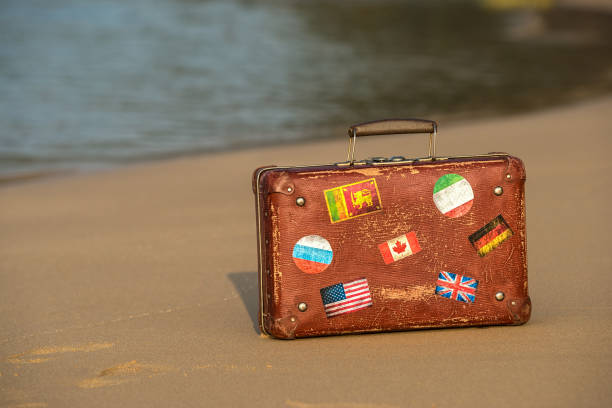 istock Travel  vintage suitcase is alone on a beach 1125676517