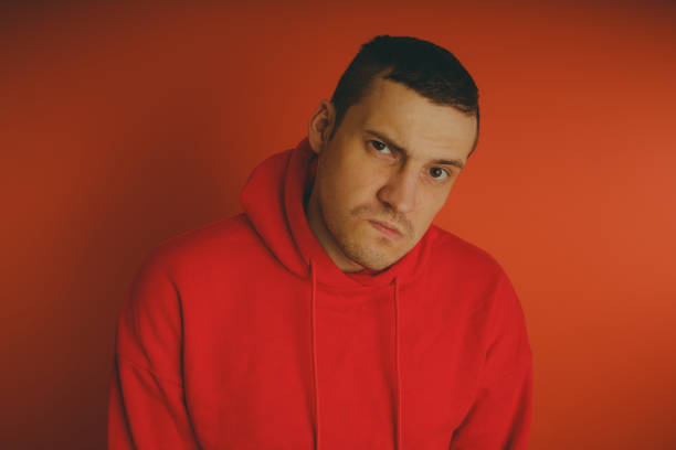 istock Crazy and charismatic guy posing on an orange background. 1125676521