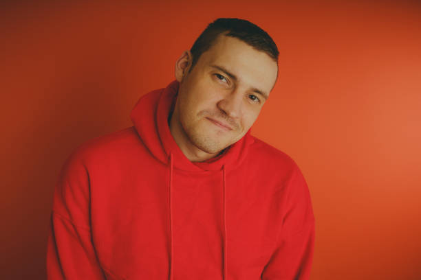 istock Crazy and charismatic guy posing on an orange background. 1125676536