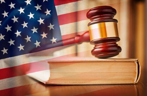 istock Judges gavel with law book and US flag 1125676570