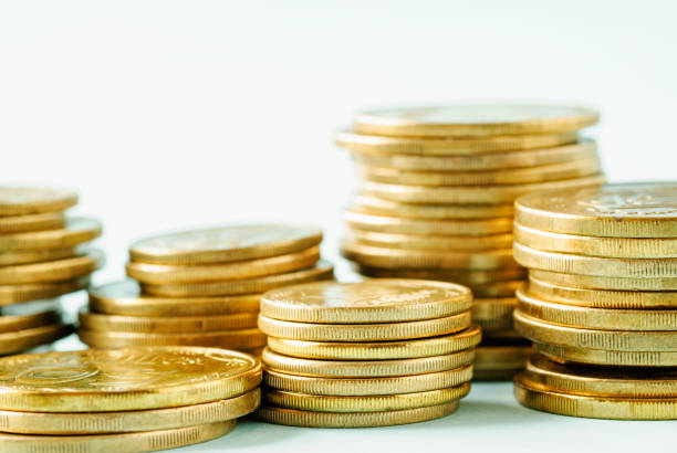 istock Stacked piles of gold coins over white 1125676573