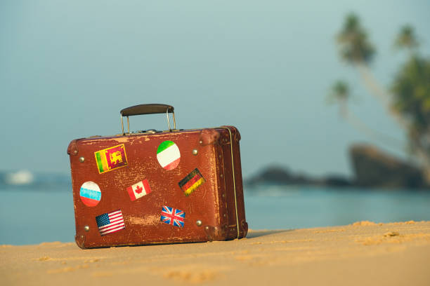 istock Travel  vintage suitcase is alone on a beach 1125676590