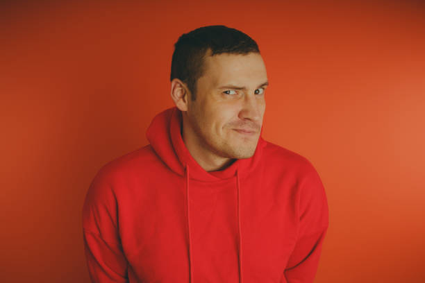 istock Crazy and charismatic guy posing on an orange background. 1125676756