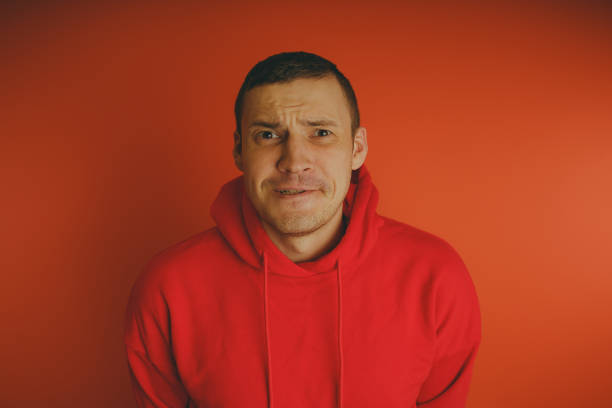 istock Crazy and charismatic guy posing on an orange background. 1125676760
