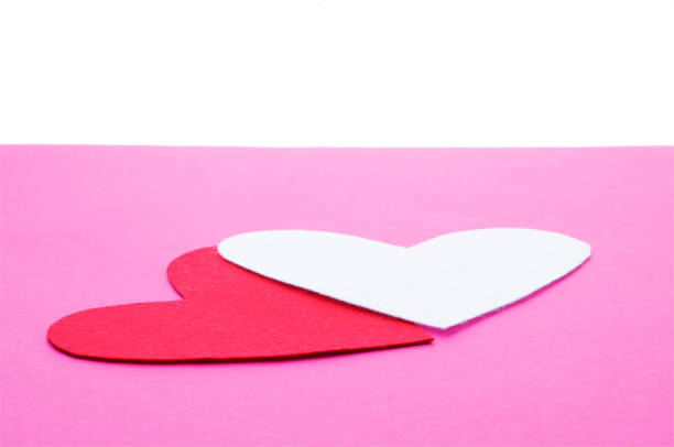istock Two felt forms of heart on the pink background 1125676808