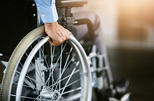 Closeup shot of an unrecognizable man sitting in a wheelchair