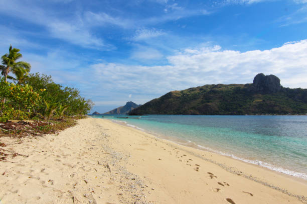The beach of the island of Kuata, in the background Wayasewa Island, Yasawa Islands, Fiji stock photo
