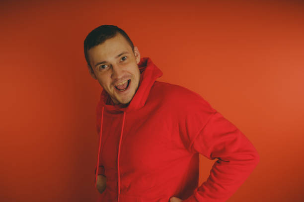 istock Crazy and charismatic guy posing on an orange background. 1125677037