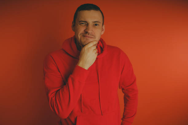 istock Crazy and charismatic guy posing on an orange background. 1125677082