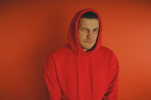 istock Crazy and charismatic guy posing on an orange background. 1125677527