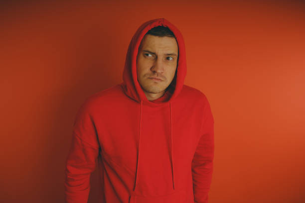 istock Crazy and charismatic guy posing on an orange background. 1125677576