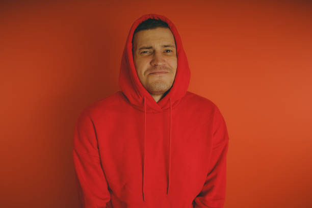istock Crazy and charismatic guy posing on an orange background. 1125677578