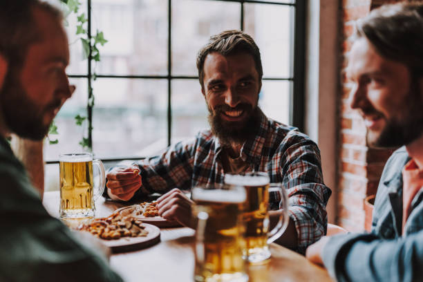 istock Cheerful bearded man spending time with friends at pub 1125678317