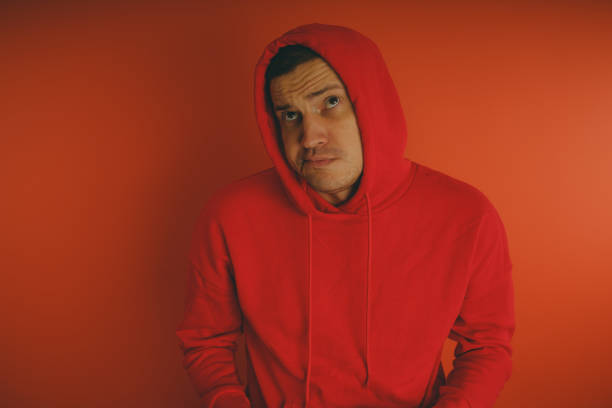 istock Crazy and charismatic guy posing on an orange background. 1125678382