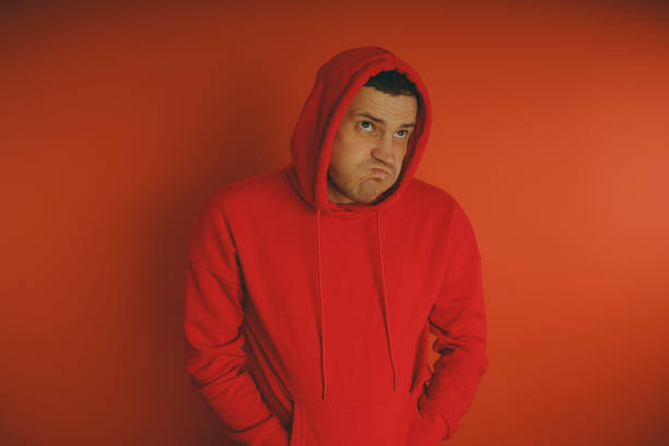 istock Crazy and charismatic guy posing on an orange background. 1125678388