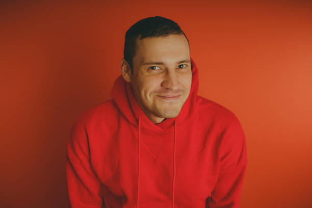 istock Crazy and charismatic guy posing on an orange background. 1125678986