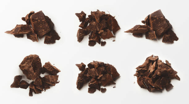 istock Collection of broken chocolate pieces on white background 1125679371