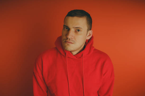 istock Crazy and charismatic guy posing on an orange background. 1125679605