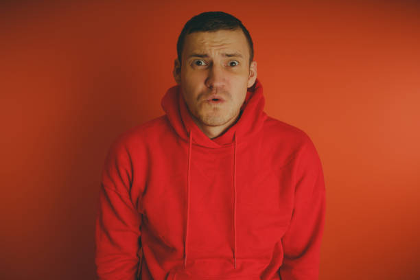 istock Crazy and charismatic guy posing on an orange background. 1125679755