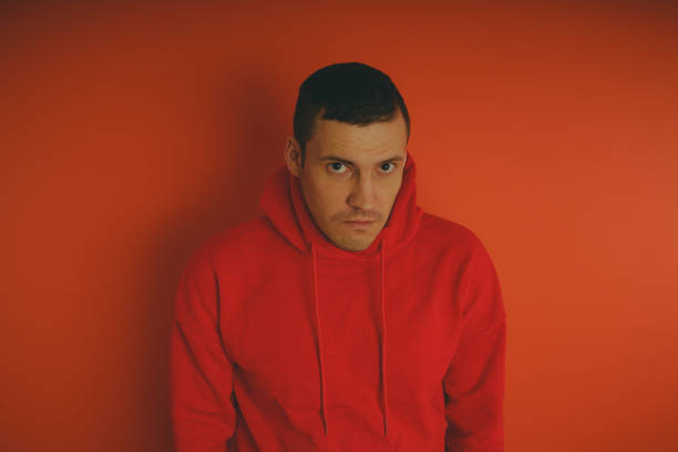 istock Crazy and charismatic guy posing on an orange background. 1125679764