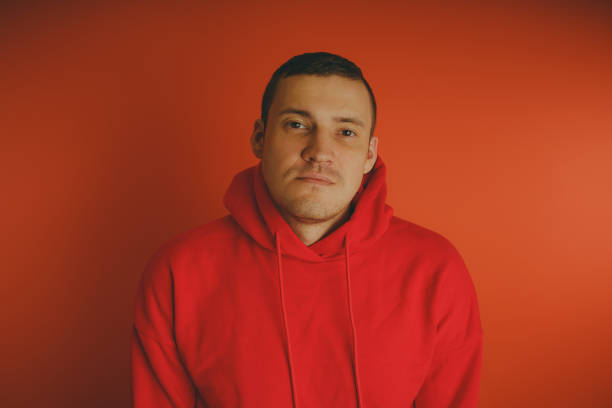 istock Crazy and charismatic guy posing on an orange background. 1125679776