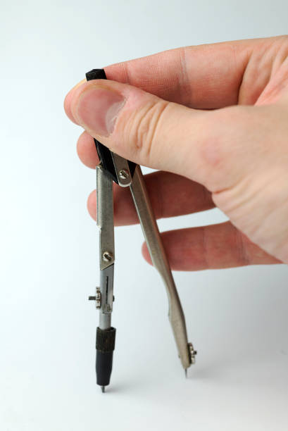 istock Hand holds a pair of compasses. 1125679832