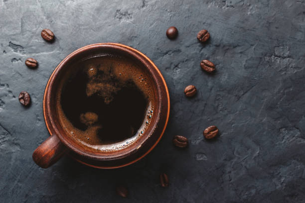 istock Coffee cup on the dark, textured background, top view 1125680278