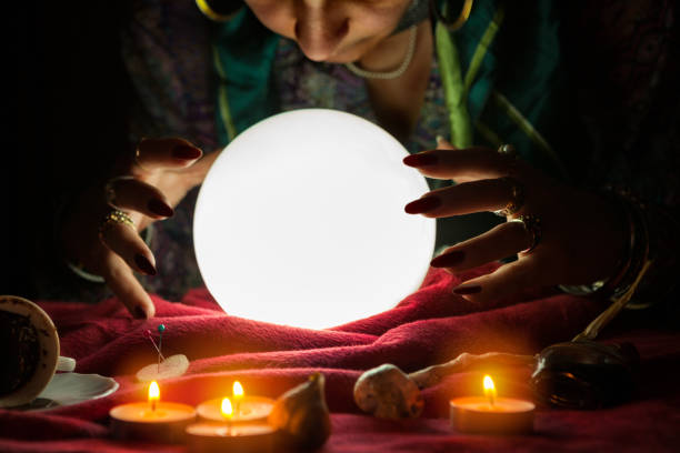 istock Fortune teller woman looking at crystal ball 1125680813