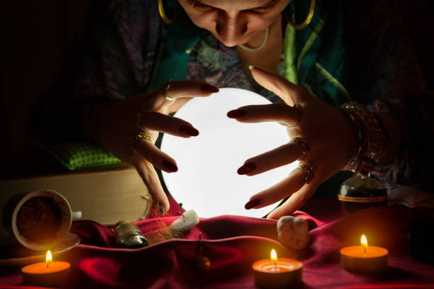 istock Woman fortune teller looking at crystal ball 1125681389