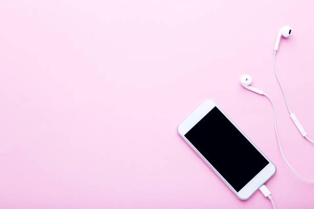 istock Smartphone with earphones on pink background 1125681982