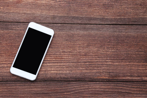 istock Smartphone on brown wooden table 1125682157