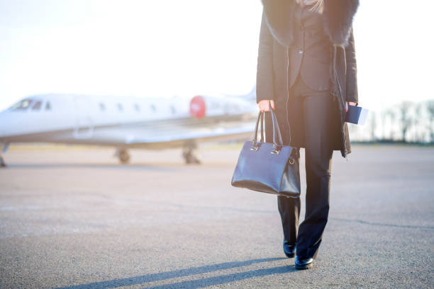 Young businesswoman leaving private jet airplane stock photo