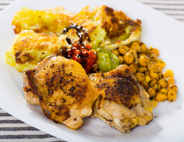istock Baked chicken thighs with cabbage in batter, garbanzos, sauces 1125682534