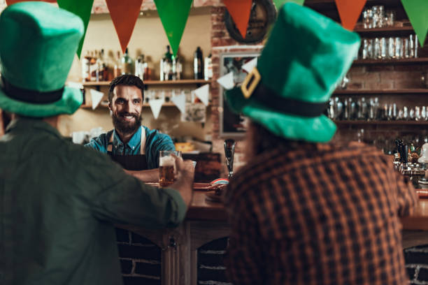 istock Cheerful barman in apron communicating with visitors 1125684160