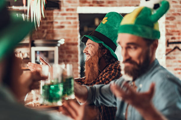 istock Cheerful young man celebrating Saint Patrick Day with friends at pub 1125684218