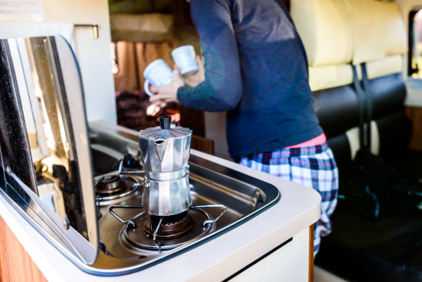 istock Cooking coffee in campervan, caravan or RV on camping trip. 1125684510