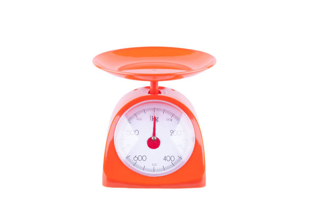 orange scales weighing products on white background kitchen equipment object isolated