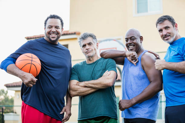 istock Multi-ethnic group of middle aged men playing basketball 1125684759