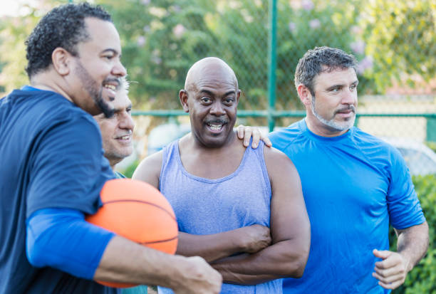 istock Multi-ethnic group of middle aged men playing basketball 1125684761