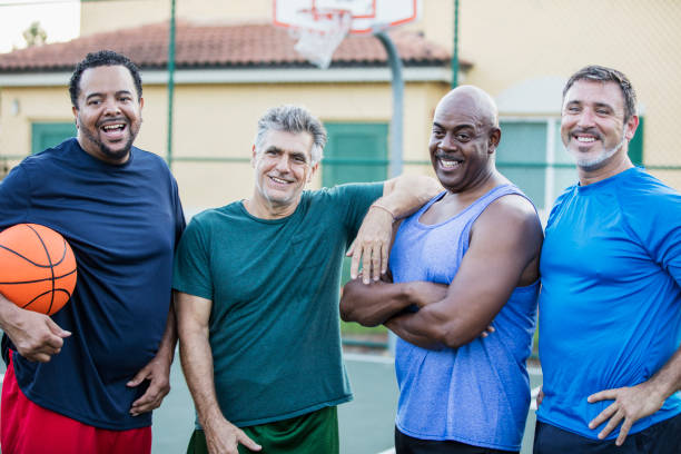 istock Multi-ethnic group of middle aged men playing basketball 1125685108