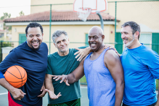 istock Multi-ethnic group of middle aged men playing basketball 1125685141