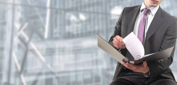 istock Business man consults folders in a binder 1125685211