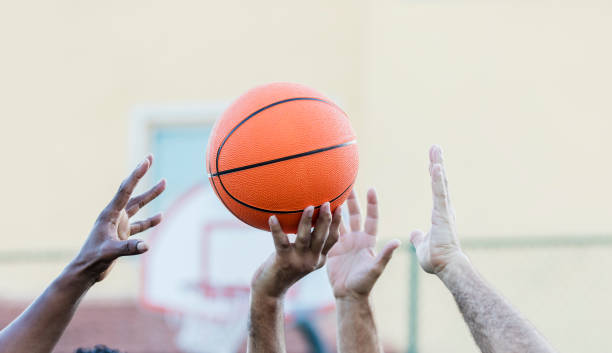 istock Men's hands reaching for basketball 1125685269