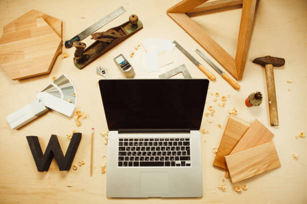 istock Carpentry work tools and laptop on background with wooden cuttings. 1125686139