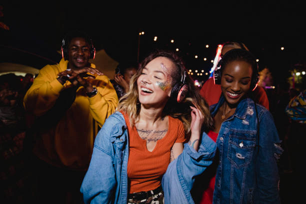Young Woman at Silent Disco Young woman is dancing in a silent disco with her friends. clubbing stock pictures, royalty-free photos & images