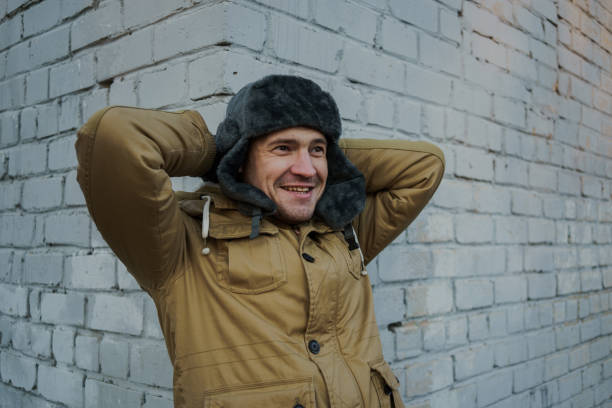 istock Happy handsome young man in cap with earflaps. 1125688546