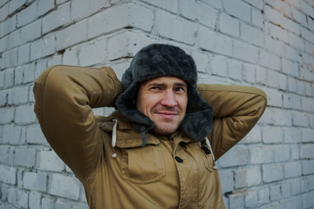 istock Happy handsome young man in cap with earflaps. 1125688572