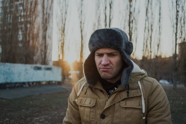 istock Happy handsome young man in cap with earflaps. 1125688583