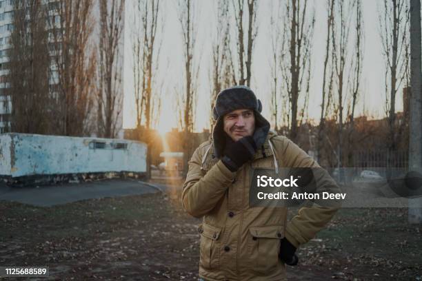 Happy Handsome Young Man In Cap With Earflaps Stock Photo - Download Image Now - Adult, Adults Only, Beautiful People