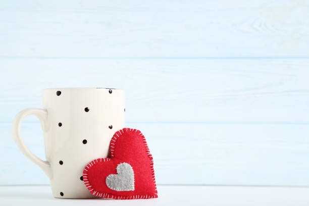istock Fabric heart with cup on wooden background 1125689235